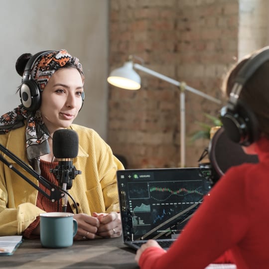 young lady wearing headphones and talking at the microphone