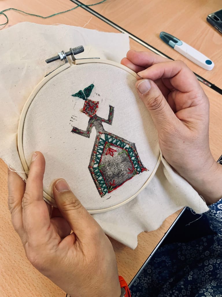 Picture of hands holding a stitching piece