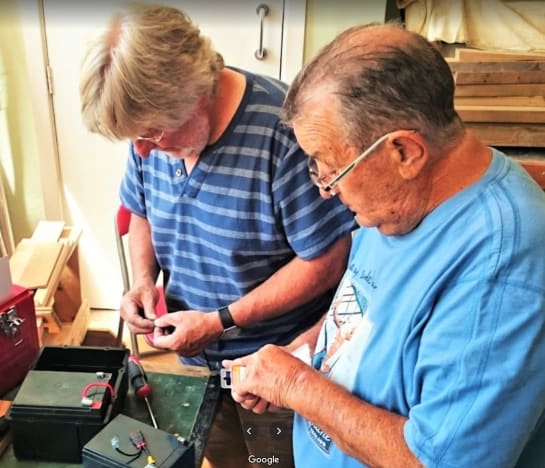 Picture of two men repairing