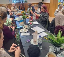 Mother Hookers crochet group at the table