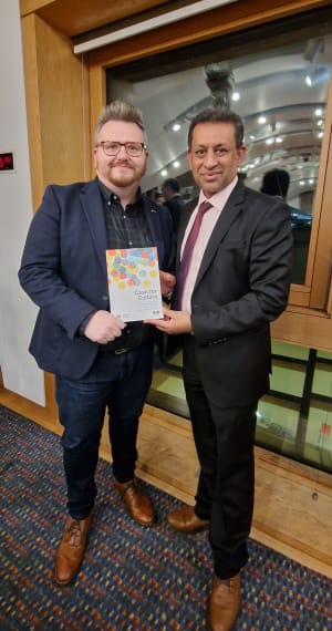 David McDonald presenting a copy of our Cash for Culture resource to convener Foysol Choudhury, MSP for Lothian